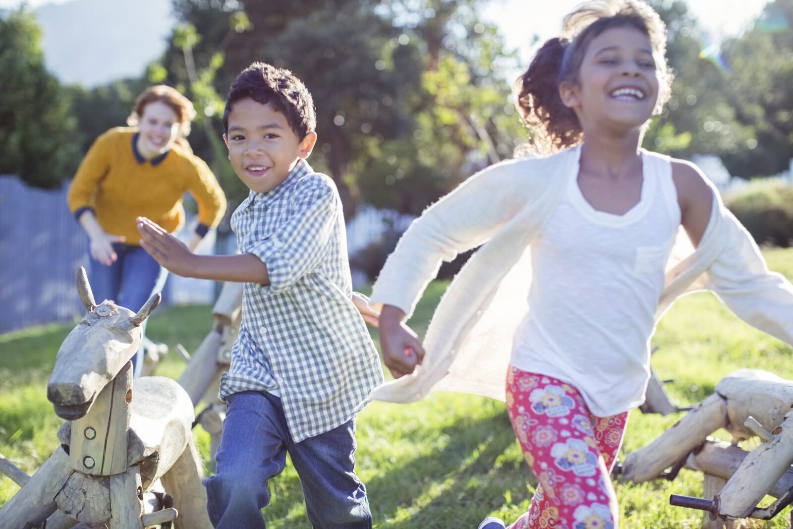 Children running and playing outdoors in bright sunlight